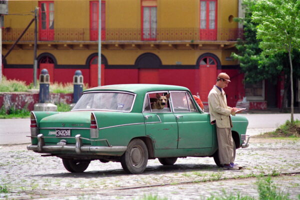La Boca, Buenos Aires circa 1990. Artist workign on his sketch with his dog and a Siam Di Tella, A car that was popular as a tax in the 70's. photo Eddie Arrossi.